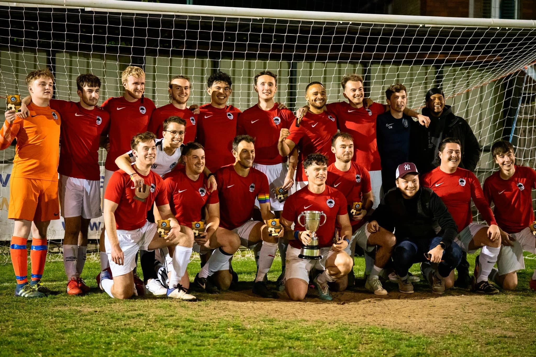 Red-shirt squad celebrating with the cup